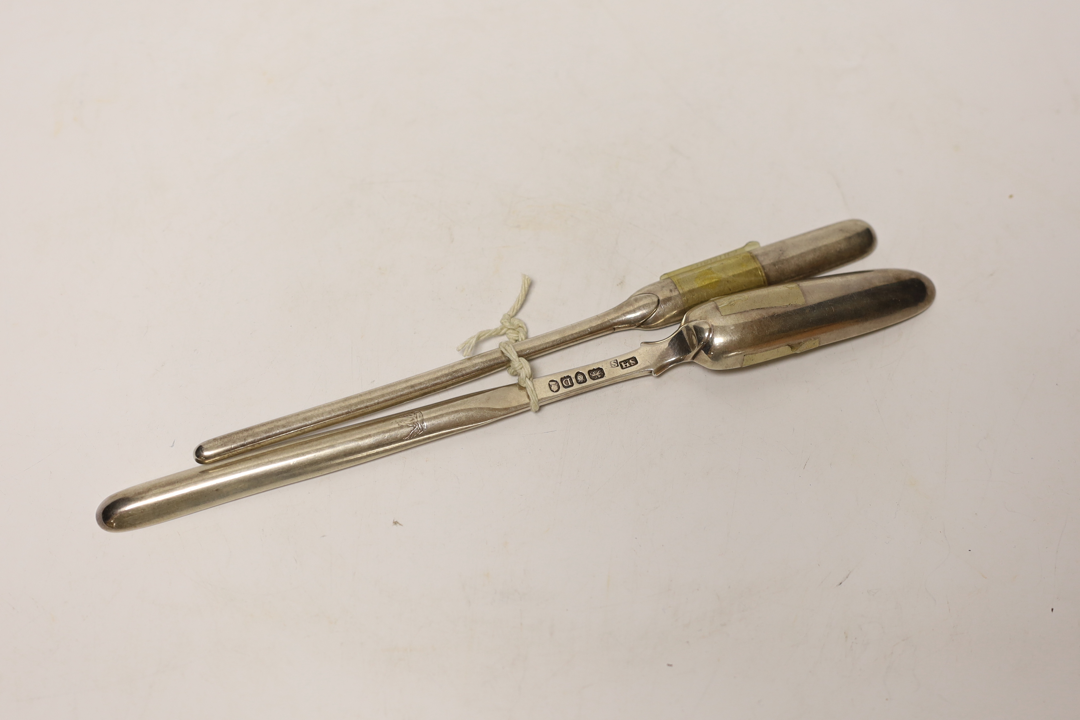 Two 18th century silver marrow scoops, the smaller unmarked, the other Soloman Hougham, London, 1799, 24.2cm, 96 grams.